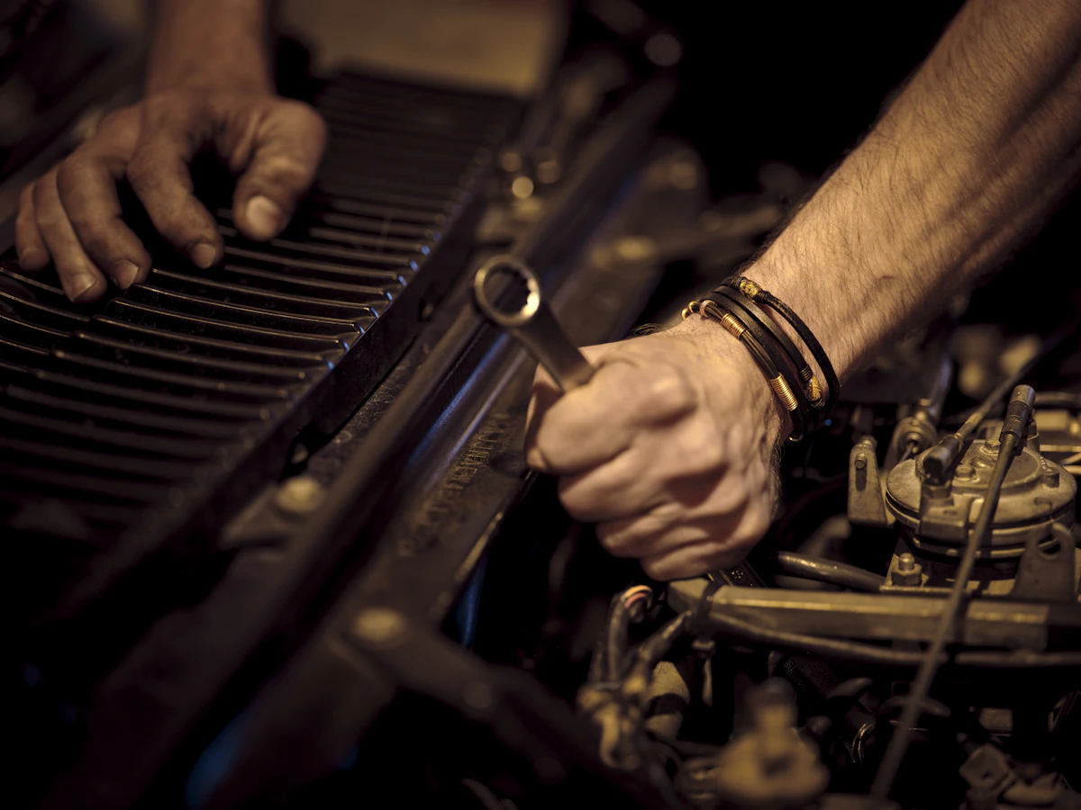 Hands carrying out an oil and filter change on a car engine